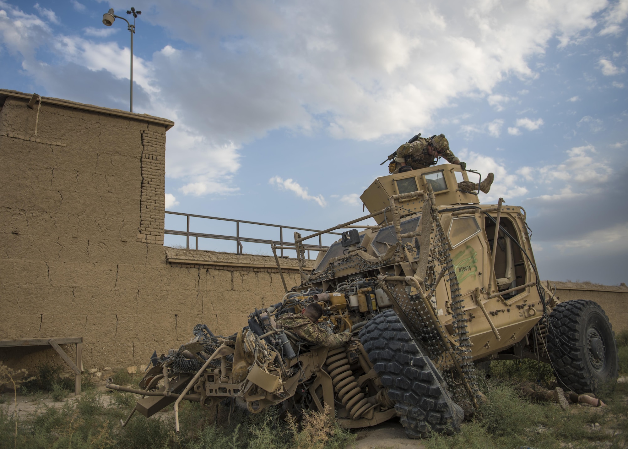 A pararescue specialist from the 83rd Expeditionary Rescue Squadron, attends to Senior Airman Joshua Calara, 455th Expeditionary Maintenance Squadron armament systems technician, during a joint mass casualty and extraction exercises, Bagram Airfield, Afghanistan, Aug. 18, 2016. Airmen from the 83rd ERQS, paired with soldiers from the 717th Explosive Ordinance Disposal Unit to increase interoperability with each other and demonstrate theater personnel recovery capabilities. Before pararescue specialist could care for and recover wounded patients, EOD members, cleared and secured the area by identifying, removing and disposing of simulated ordnance in the area and from crashed vehicles carrying explosives. (U.S. Air Force photo by Senior Airman Justyn M. Freeman)