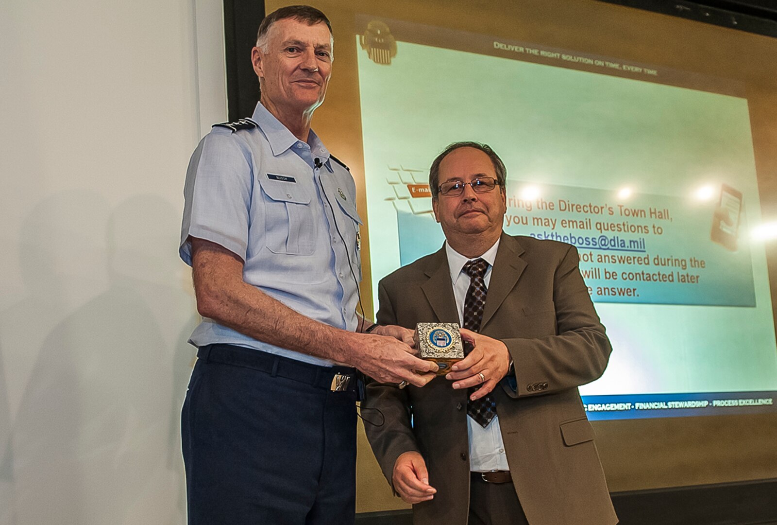 DLA Director Air Force Lt. Gen. Andy Busch presented the Land and Maritime Supervisor of the Month for June to Tom Bunnell Aug. 17 inside DSCC’s Building 11 auditorium during a town hall. Bunnell is a branch chief in the Strategic Acquisition Programs Directorate.