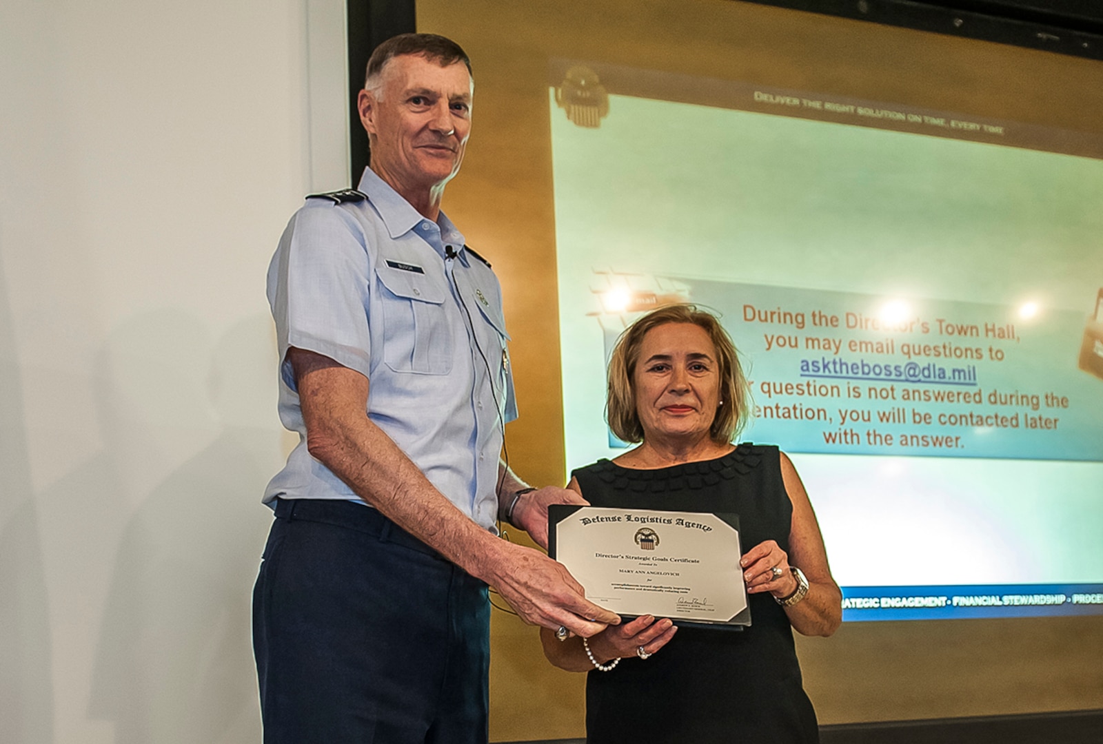 DLA Director Air Force Lt. Gen. Andy Busch presented the Warfighter First Strategic Goals Award to Mary Ann Angelovich Aug. 17 inside DSCC’s Building 11 auditorium during a town hall. Angelovich works as a Purchasing Agent with Land Supplier Operations.