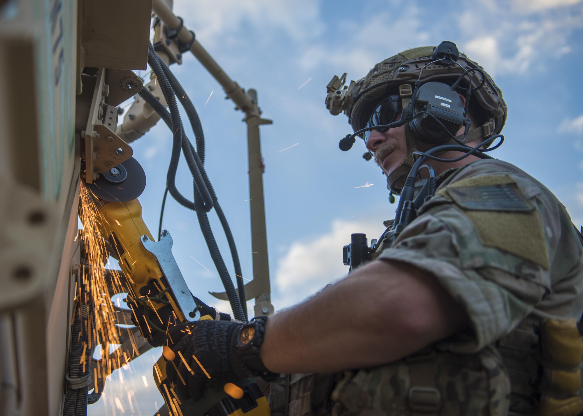 Senior Airman Kyle Green, 83rd Expeditionary Rescue Squadron pararescue specialist cuts the hinges on a mine-resistant, ambush-protected vehicle door, Bagram Airfield, Afghanistan, Aug. 18, 2016. The 83rd ERQS worked with Soldiers from the 717th Explosive Ordinance Disposal Unit to identify, remove and dispose of simulated ordnance in the area and from crashed vehicles carrying explosives, before rescuing and recovering the injured. (U.S. Air Force photo by Senior Airman Justyn M. Freeman)