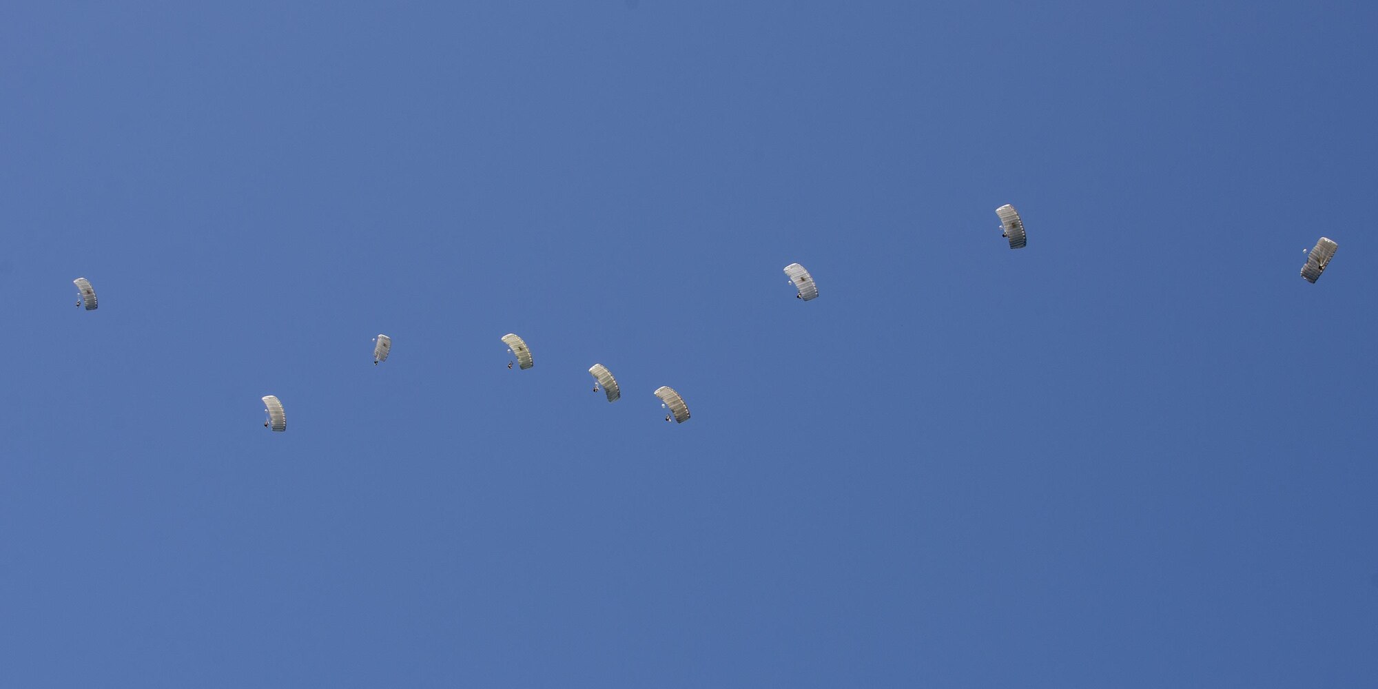 Pararescuemen from the 38th Rescue Squadron drift through the sky during a high-altitude, low-opening jump, Aug. 18, 2016, at Moody Air Force Base, Ga. Training jumps are typically conducted from 9,000 to 12,000 feet, but current deployed operations require an airdrop of 20,000 feet or more. (U.S. Air Force photo by Airman 1st Class Daniel Snider)
