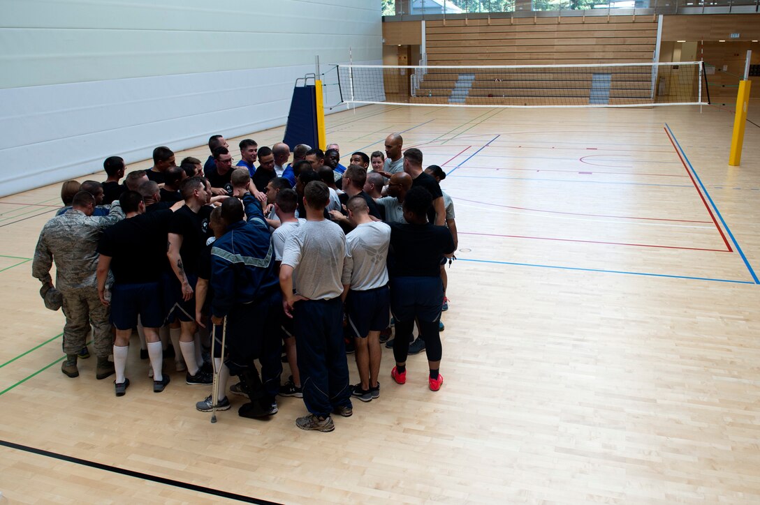 Saber Airmen gather for a chant after a volleyball game between Spangdahlem’s ALS students and Saber senior NCOs at the Eifel Powerhouse on Spangdahlem Air Base, Germany, Aug. 17, 2016. The event marked the second time students at Spangdahlem defeated senior NCOs in the past 21 games.