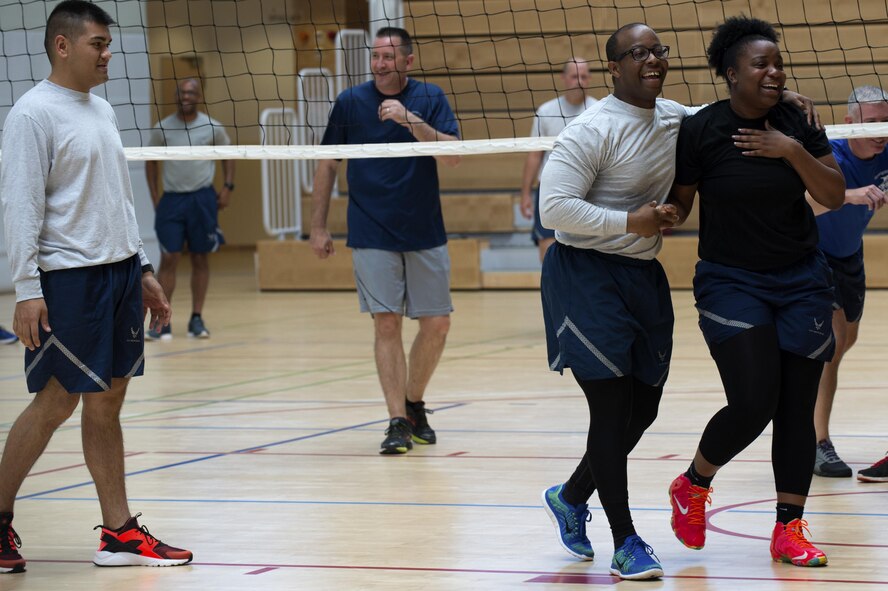 U.S. Air Force Senior Airman Nathan Little, right center, and Senior Airman Tonyea Jackson, right, both Airman Leadership School students, laugh with each other after a collision during a volleyball game at the Eifel Powerhouse on Spangdahlem Air Base, Germany, Aug. 17, 2016. Traditionally, Saber senior NCOs challenge ALS students at Spangdahlem to compete in a volleyball match in a friendly rivalry game.