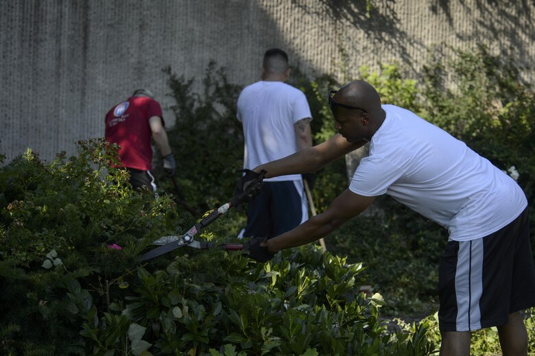 Senior Airman Donald Irby an air transportation technician with the 76th Aerial Port Squadron, Youngstown-Warren Air Reserve Station, Ohio, volunteers his time to help landscape the air park on Spangdahlem Air Base, Germany, Aug. 17, 2016. The park was opened in Sept. 1997 to allow base personnel to reflect on the history, honor and mission of past Saber team members. (U.S. Air Force photo by Staff Sgt. Jonathan Snyder)