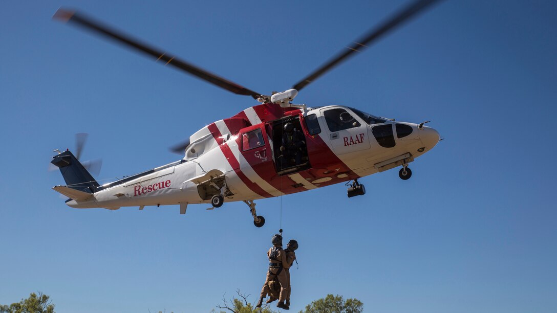 Marine Fighter Attack Squadron 122 U.S. Navy Lt. Matthew Case, flight surgeon, and U.S. Navy Petty Officer 3rd Class Juan Garcia, hospital corpsman, are hoisted into a Sikorsky S76A++ Search and Rescue helicopter while conducting SAR training during Exercise Pitch Black 2016 at Royal Australian Air Force Base Tindal, Australia, August 16, 2016.  The SAR team trains with local and international forces during exercises like Pitch Black to ensure all medical personnel that can respond to an aircraft emergency are capable of carrying out the same procedures. The biennial, multinational exercise involves approximately 10 allied nations and prepares these forces for possible real-world scenarios. The bilateral effort amongst Exercise Pitch Black 2016 furthermore showcases the strength amongst various militaries and solidifies the relationship across the Pacific region. 