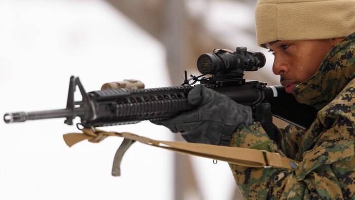 Lance Cpl. Samuel L. Posey, a rifleman with 3rd Platoon, Company I, 3rd Battalion, 25th Marine Regiment, 4th Marine Division, Marine Forces Reserve, sights in through his rifle while conducting room clearing drills during exercise Arctic Eagle at Camp Grayling, Mich., April 7, 2016.  Posey overcame a rough childhood to become a Marine and serve his country.