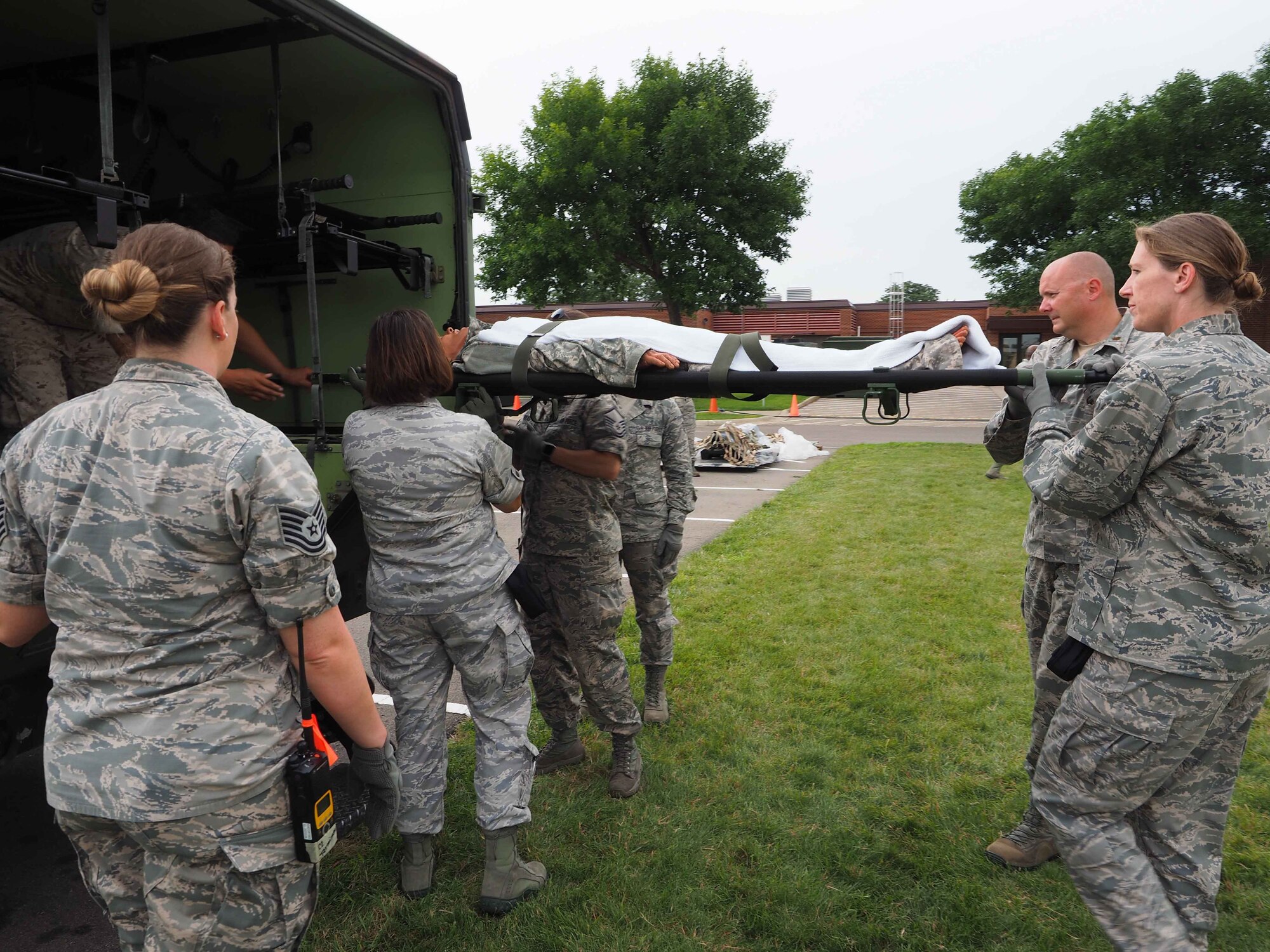 Members of the 911th Aeromedical Staging Squadron from Pittsburgh Air Reserve Station, Pa. transport "patients" from an En Route Patient Staging System 10 bed facility to a larger 50 patient facility. 