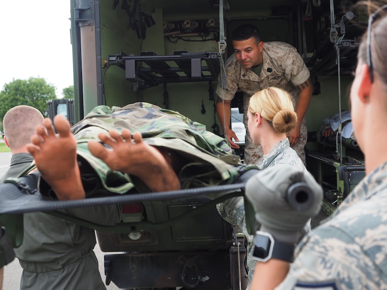 Members of the 911th Aeromedical Staging Squadron from Pittsburgh Air Reserve Station, Pa. transport "patients" from an En Route Patient Staging System 10 bed facility to a larger 50 patient facility. 