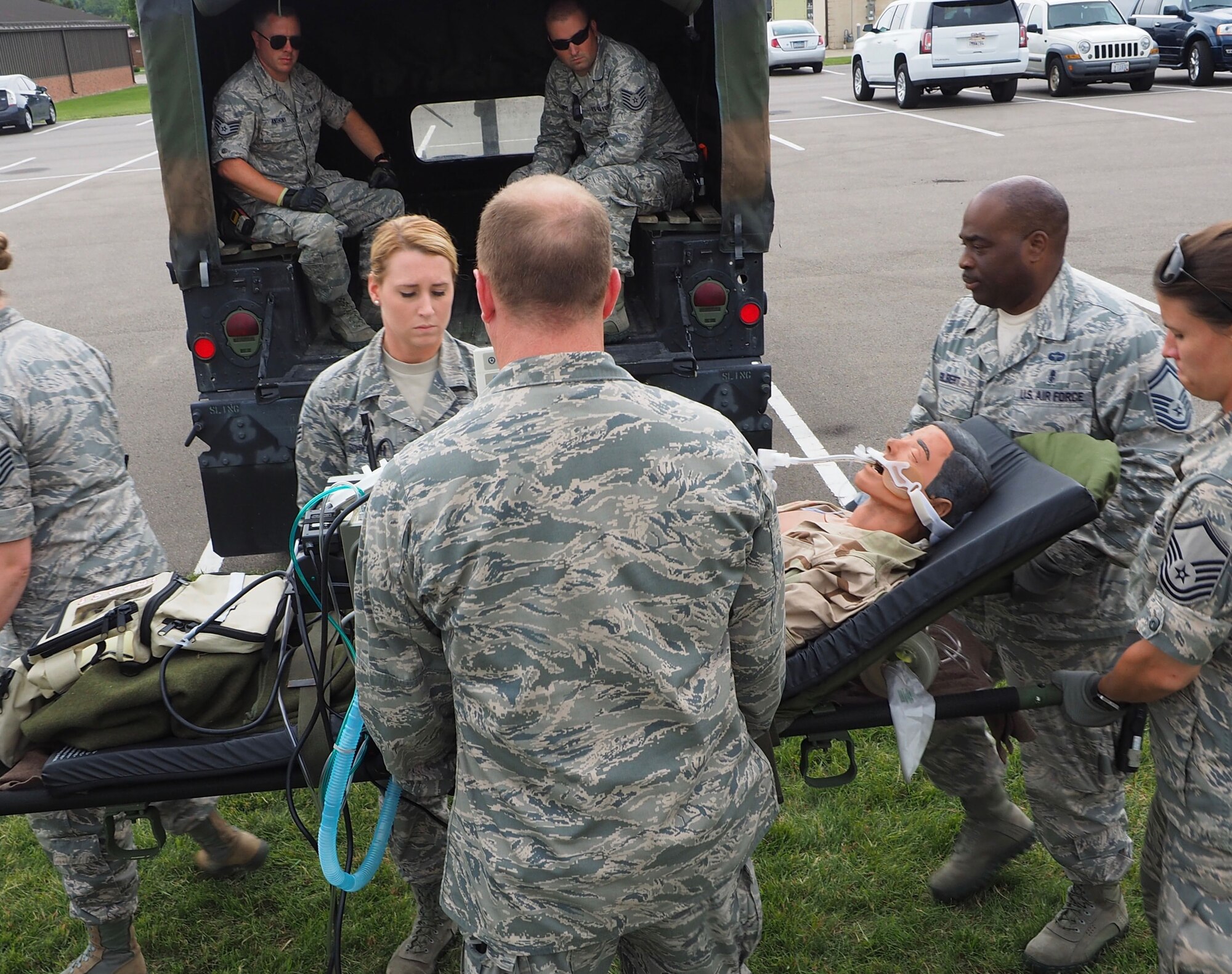 Members of the 911th Aeromedical Staging Squadron from Pittsburgh Air Reserve Station, Pa. transport "patients" from an En Route Patient Staging System 10 bed facility to a larger 50 patient facility. 