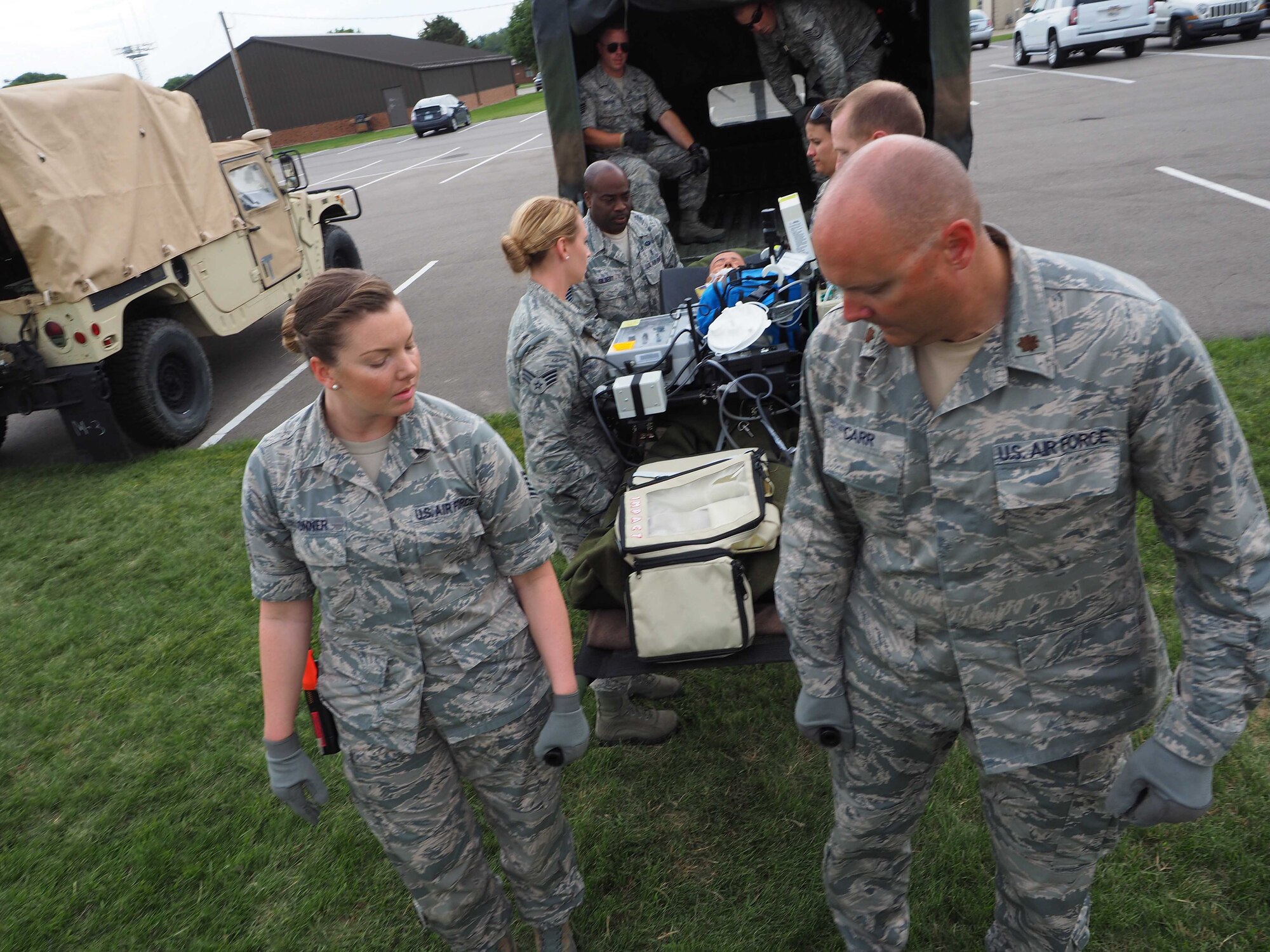 Members of the 911th Aeromedical Staging Squadron from Pittsburgh Air Reserve Station, Pa. transport "patients" from an En Route Patient Staging System 10 bed facility to a larger 50 patient facility. 