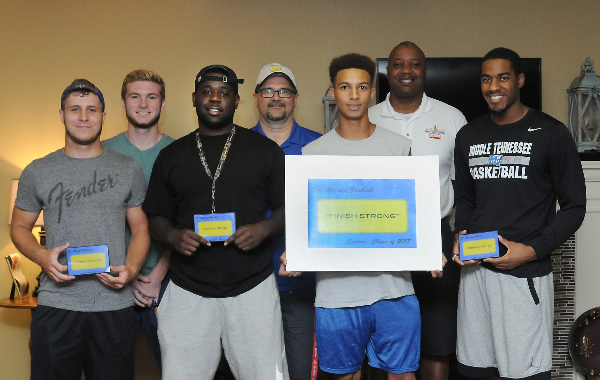 Keesler personnel take a photo with St. Martin High School senior football players during a leadership seminar Aug. 13, 2016, at Center Pointe Church in Ocean Springs, Miss. The seminar was a collaboration of the St. Martin Gridiron Club and Keesler personnel who demonstrated the value of being better leaders by adopting good attitudes, values, beliefs and teamwork to the students.  (Courtesy photo/Kemberly Groue)