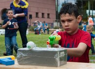 A child squirts a ping pong ball with a water gun during a party for families of deployed Airmen Aug. 12, 2016 at Ramstein Air Base, Germany. The event was hosted by the Airman and Family Readiness Center and the Ramstein Enlisted Spouses’ Association and aimed to bring Kaiserslautern Military Community families together to enjoy a fun, family-friendly environment. (U.S. Air Force photo/Airman 1st Class Lane T. Plummer)