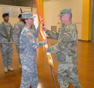 Col. Jean Henderson, a Wheaton, Illinois native and 505th Theater Tactical Signal Brigade incoming commander, is passed the unit guidon from Brig. Gen. Christopher R. Kemp, 335th Signal Command (Theater) commanding general, East Point, Georgia, during a change of command ceremony at the Taylor Hall U.S. Army Reserve Center in Las Vegas August 14, where Col. Matthew Easley, has led the unit for two years.