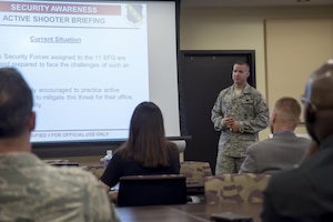 Staff Sgt. Courtney Corral, 11th Security Support Squadron training instructor, briefs members of Joint Base Andrews, Md., during active shooter training at the Jacob E. Smart Building on base, Aug. 17, 2016. The training, held by the 11th SSPTS, instructed attendees on how to react during an active shooter incident in specific office locations. Attendees also had the opportunity to implement the training they learned during an active shooter drill. (U.S. Air Force photo by Airman Gabrielle Spalding)