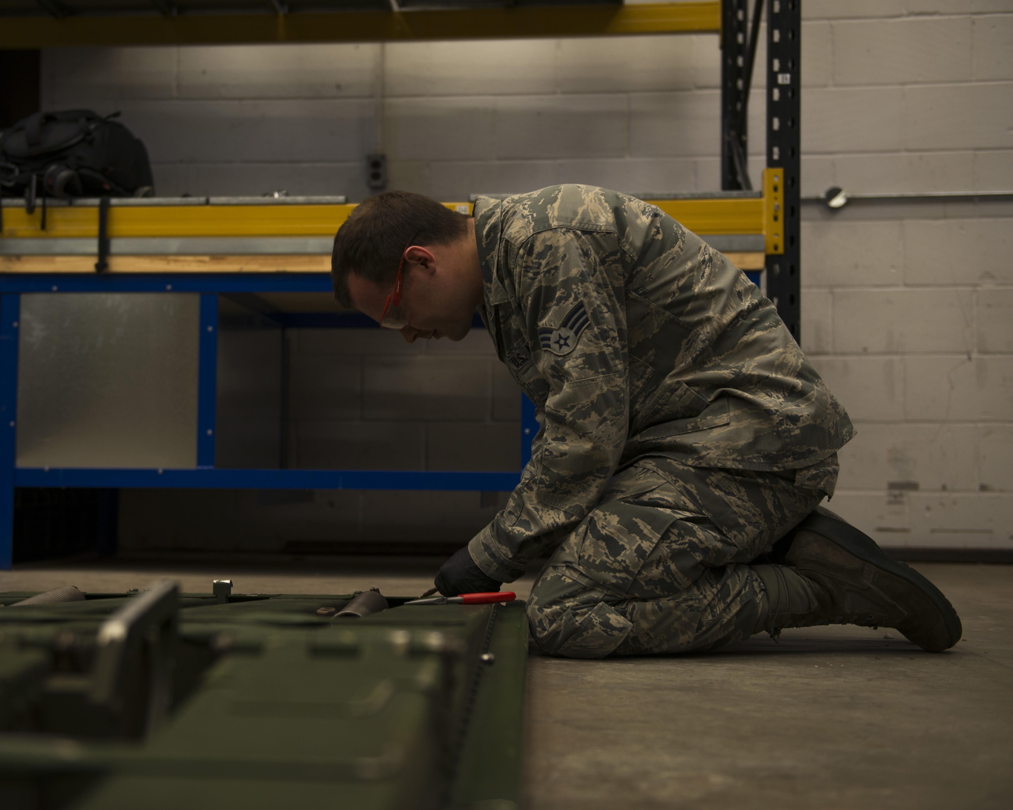 U.S. Air Force Senior Airman Christopher Elgin, 352d Special Operations Aircraft Maintenance Squadron repair and reclamation journeyman, repairs and rigs an auxiliary bi-folding ramp on RAF Mildenhall, England, Aug. 19, 2016. The repair and reclamation shop, or AR-21, consists of trained MC-130J Commando II crew chiefs who work outside normal flightline duties to perform a variety of maintenance functions with longer timelines, allowing their counterparts to focus on aircraft servicing, marshalling and other associated tasks. (U.S. Air Force photo by 1st Lt Chris Sullivan/Released)