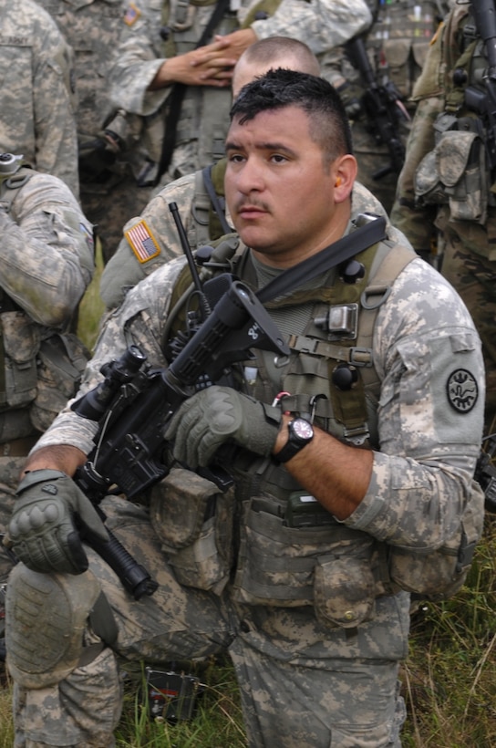 Army Sgt. Sergio Calderon-Diaz, a team leader with Bravo Company, 3rd Battalion, 116th Cavalry Brigade Combat Team, takes a knee after patrol and assault training during Exercise Saber Guardian 16 at the Romanian Land Forces Combat Training Center in Cincu, Romania, Aug. 2, 2016. Oregon Army National Guard photo by Staff Sgt. Anita VanderMolen