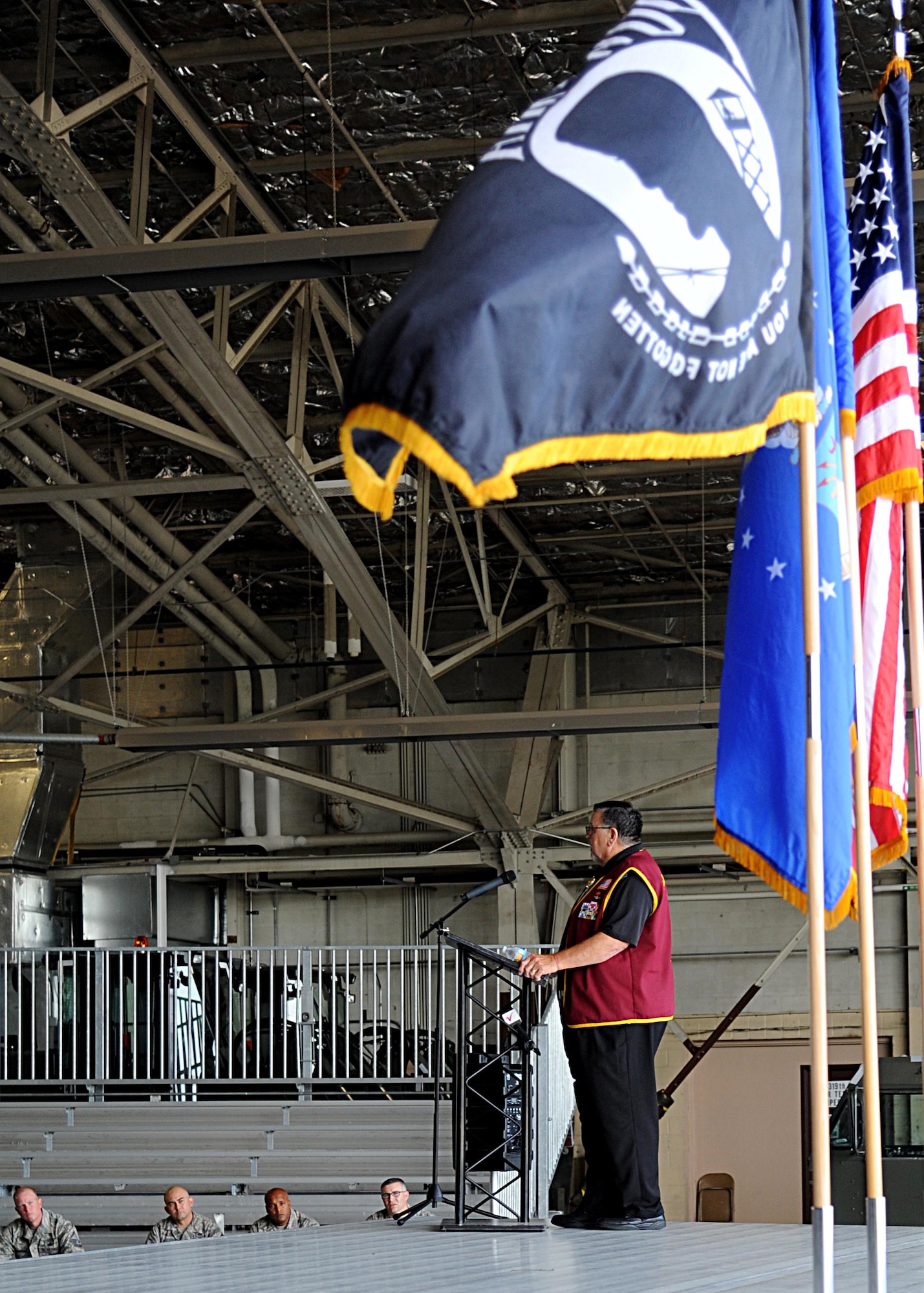 The POW/MIA flag waves in the wind as Capt. William “Bill” Robinson, United States Air Force retired, speaks with Airmen August 18, 2016, on Grand Forks Air Force Base, N.D. Robinson spent nearly eight years as a POW in Vietnam, which is the longest time spent as a POW by any enlisted member. (U.S. Air Force photo by Senior Airman Ryan Sparks/Released)