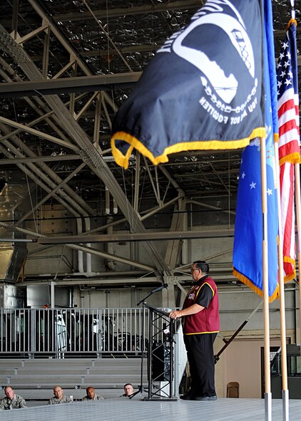 The POW/MIA flag waves in the wind as Capt. William “Bill” Robinson, United States Air Force retired, speaks with Airmen August 18, 2016, on Grand Forks Air Force Base, N.D. Robinson spent nearly eight years as a POW in Vietnam, which is the longest time spent as a POW by any enlisted member. (U.S. Air Force photo by Senior Airman Ryan Sparks/Released)