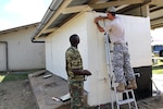 U.S. Army Staff Sgt. Louis Du Randt, right, 211th Engineer Company, South Dakota Army National Guard, and a Suriname Army soldier conduct renovation work at the O.S. 1 Santo Dorp School in Wanica, Suriname, Aug. 11, 2016. The renovation project was conducted as part of the Suriname and South Dakota State Partnership Program to provide training for military construction personnel while simultaneously assisting in a worthy community need.