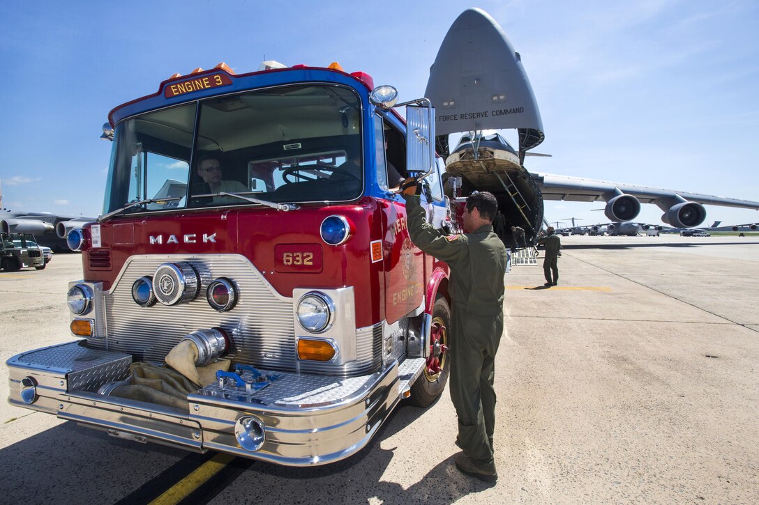 Airmen load a firetruck into a C-5B Galaxy aircraft at Joint Base McGuire-Dix-Lakehurst, N.J., Aug. 12, 2016. The truck, which can pump 1,250 gallons per minute, is slated to travel to Managua, Nicaragua. The airmen are loadmasters assigned to the 439th Airlift Wing, Air Force Reserve Command. Air National Guard photo by Master Sgt. Mark C. Olsen