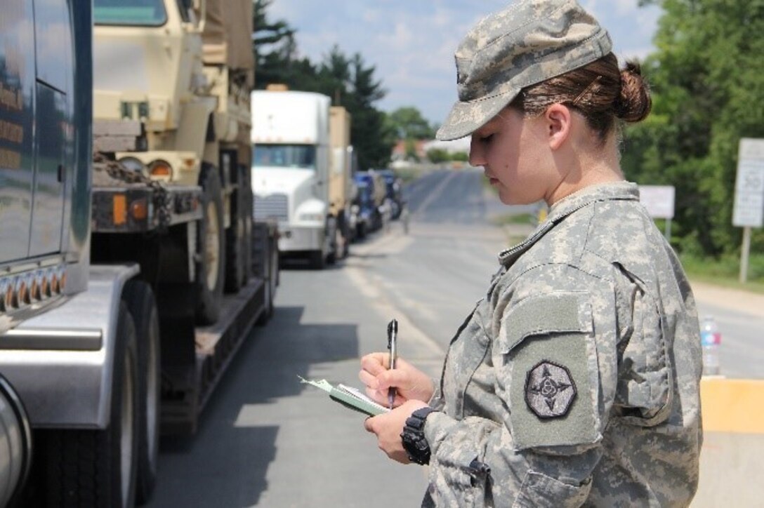 Trucks align outside of the CRSP yard as Cpl. Chris Ottoman checks for serial numbers on the incoming cargo at the gate of the CRSP yard. (Photo by: SPC Aaron Piega/Released)