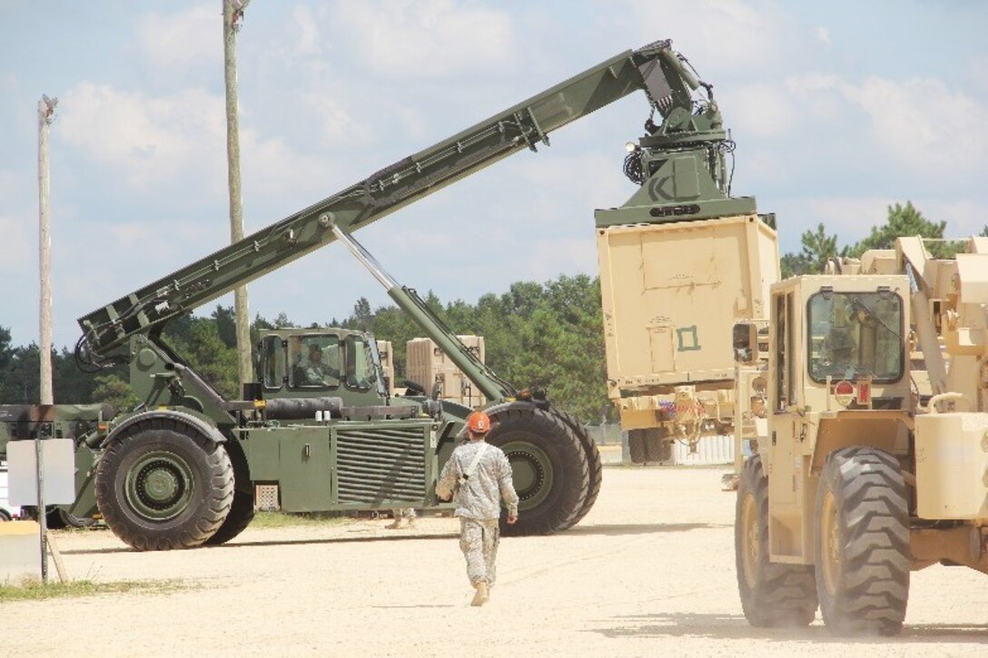 477th Transportation Company mechanical handling equipment operators load and offload cargo with the RTCH Kalmar and Atlas throughout the CRSP yard during their annual training at Ft. McCoy, Wisconsin Aug 6-26. (Photo by: SPC Aaron Piega/Released)