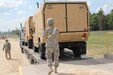 Army Reserve Soldier, Cpl. Savannah Spencer uses hand signals to carefully ground guide a tactical vehicle off of a trailer at the loading ramp located within the CRSP yard during her unit's annual training at Fort McCoy's CSTX Aug. 6-26.(Photo by: SPC Aaron Piega/Released)