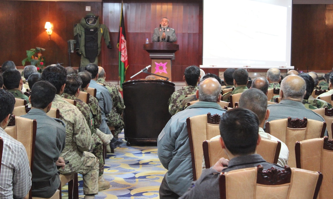 Explosive ordnance disposal technicians from the Afghan National Army, Afghan National Police and the National Directorate of Security look on as Gen. Mohammad Anwar Paigham, the Ministry of the Interior Engineering Director, thanks them for risking their lives in the fight against improvised explosive devices and unexploded ordnance. More than 120 EODs were gathered for the five-day event, where participants exchanged ideas and discussed best practices for combatting explosives throughout Afghanistan. (U.S. military photo by Lt. Charity Edgar/Released)