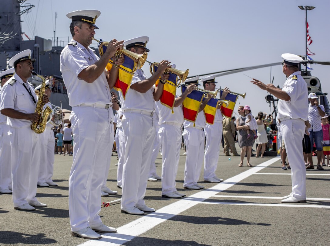 The Romanian Navy Band perform for Romanian citizens, U.S. Marines from the Black Sea Rotational Force, and U.S. soldiers stationed at Mihail Kogălniceanu Air Base on Open Gates Day at the Naval Port of Constanța, Romania, Aug. 6, 2016. Black Sea Rotational Force is an annual multilateral security cooperation activity between the U.S. Marine Corps and partner nations in the Black Sea, Balkan and Caucasus regions designed to enhance participants’ collective professional military capacity, promote regional stability and build enduring relationships with partner nations. (U.S. Marine Corps photo by Lance Cpl. Timothy J. Lutz)