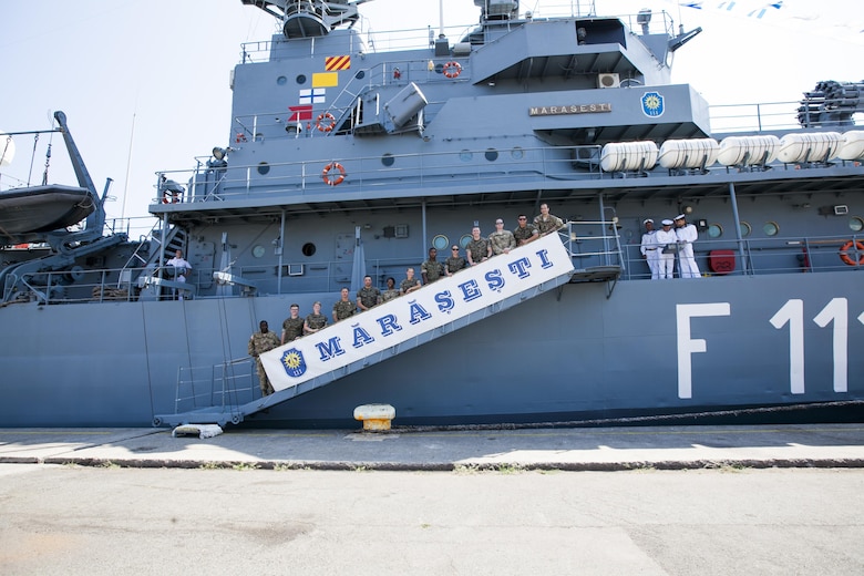 U.S Marines from the Black Sea Rotational Force Civil Affairs and U.S Army Civilian Affairs soldiers pose on the ramp of the Romanian frigate, Mărășești, during a joint Civilian Affairs engagement on Open Gates Day, two days before the anniversary of the ship's namesake, the Battle of the Mărășești, at the Naval Port of Constanța, Constanța, Romania, Aug. 6, 2016. Black Sea Rotational Force is an annual multilateral security cooperation activity between the U.S. Marine Corps and partner nations in the Black Sea, Balkan and Caucasus regions designed to enhance participants’ collective professional military capacity, promote regional stability and build enduring relationships with partner nations. (U.S. Marine Corps photo by Cpl. Kyle C. Talbot)
