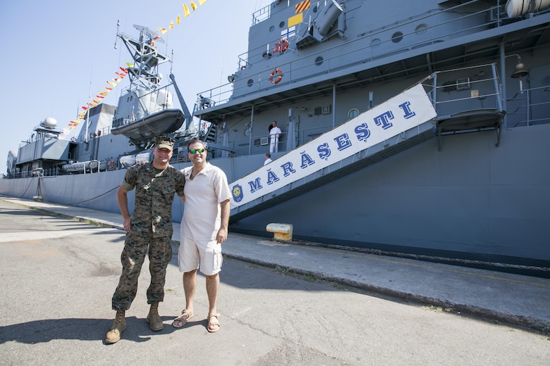 U.S. Marine Corps 1st Lt. Grant Peehler a Civil Affairs planner for the Black Sea Rotational Force poses in front of the Romanian frigate, Mărășești, during a Civilian Affairs engagement on Open Gates Day, two days before the anniversary of the ship's namesake, the Battle of the Mărășești, at the Naval Port of Constanța, Romania, Aug. 6, 2016. Black Sea Rotational Force is an annual multilateral security cooperation activity between the U.S. Marine Corps and partner nations in the Black Sea, Balkan and Caucasus regions designed to enhance participants’ collective professional military capacity, promote regional stability and build enduring relationships with partner nations. (U.S. Marine Corps photo by Cpl. Kyle C. Talbot)