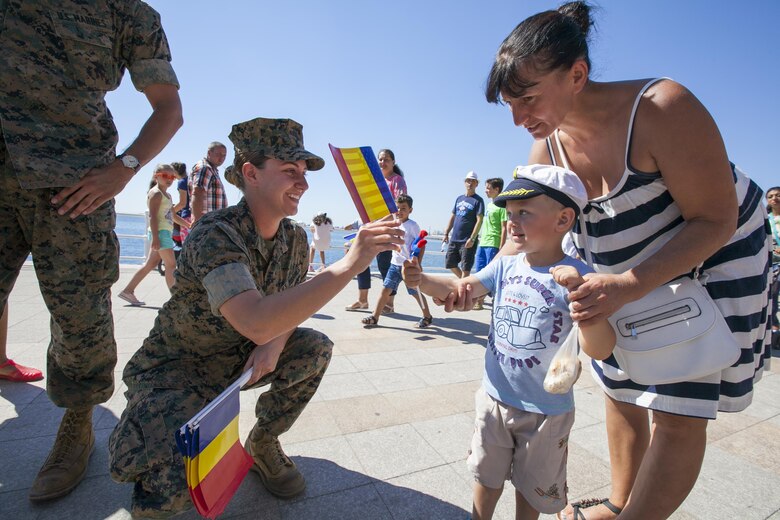 U.S. Marine Corps Cpl. Colleen Moran a U.S. Marine with the Black Sea Rotational Force 16.2 celebrates Romania’s Navy Day with community members in Constanța, Romania, Aug. 15, 2016. Marines from BSRF 16.2 were invited to the ceremony as partners and allies to maintain and strengthen our relationships so we may collectively address common security challenges in the region. Black Sea Rotational Force is an annual multilateral security cooperation activity between the U.S. Marine Corps and partner nations in the Black Sea, Balkan and Caucasus regions designed to enhance participants’ collective professional military capacity, promote regional stability and build enduring relationships with partner nations. (U.S. Marine Corps photo by Cpl. Kyle C. Talbot)