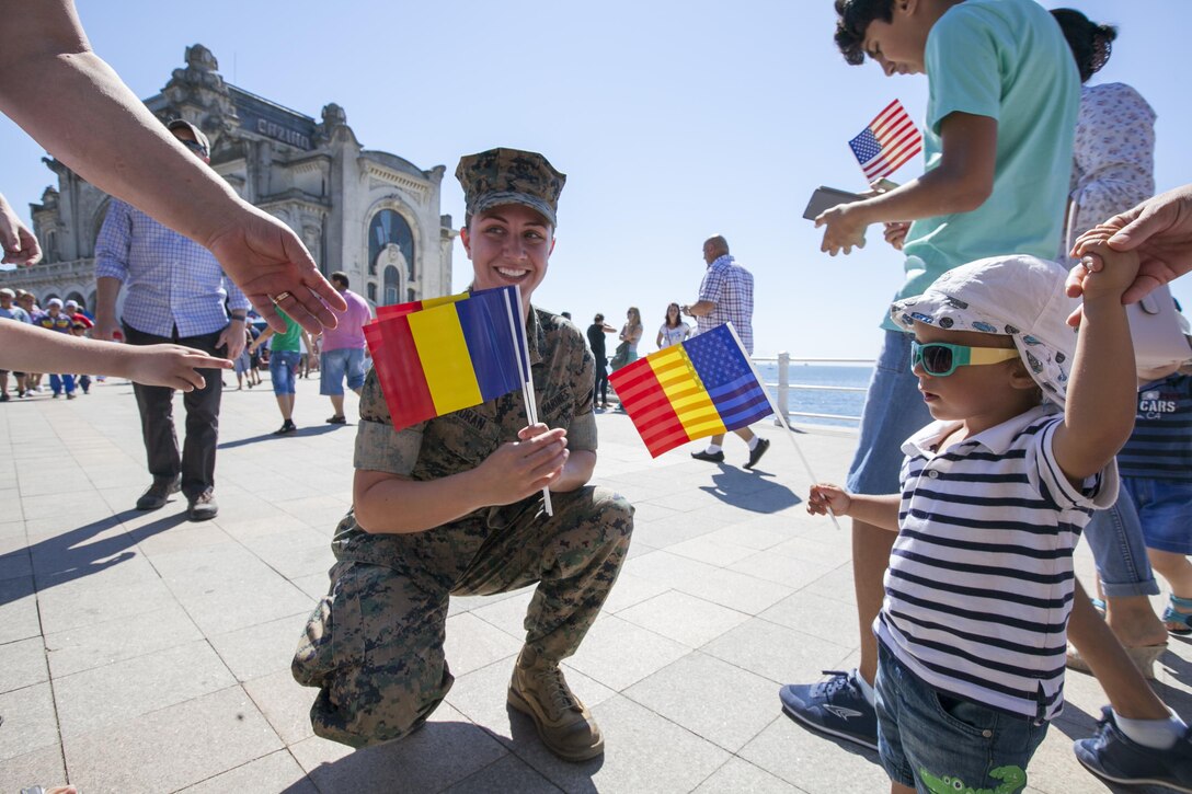 U.S. Marine Corps Cpl. Colleen Moran, a U.S. Marine with the Black Sea Rotational Force 16.2 celebrates Romania’s Navy Day with community members in Constanța, Romania, Aug. 15, 2016. Marines from BSRF 16.2 were invited to the ceremony as partners and allies to maintain and strengthen our relationships so we may collectively address common security challenges in the region. Black Sea Rotational Force is an annual multilateral security cooperation activity between the U.S. Marine Corps and partner nations in the Black Sea, Balkan and Caucasus regions designed to enhance participants’ collective professional military capacity, promote regional stability and build enduring relationships with partner nations. (U.S. Marine Corps photo by Cpl. Kyle C. Talbot)
