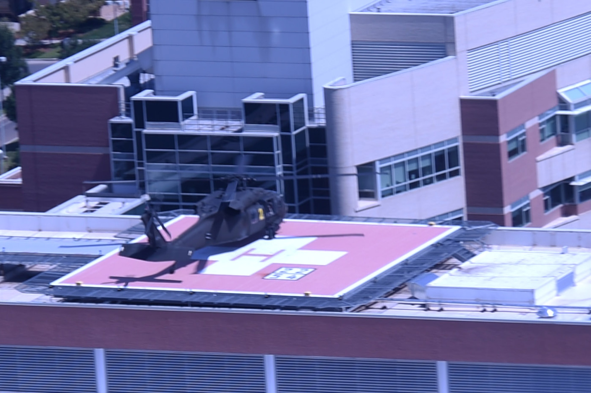 A UH-60 Black Hawk helicopter drops off patients during the annual National Disaster Medical System training exercise August 17, 2016, at the University of Colorado Hospital. The air crews picked up patients and flew them to participating hospitals where the hospital staff proceeded with their own portion of the NDMS exercise testing their medical procedures. (U.S. Air Force photo by Airman 1st Class Gabrielle Spradling/Released)