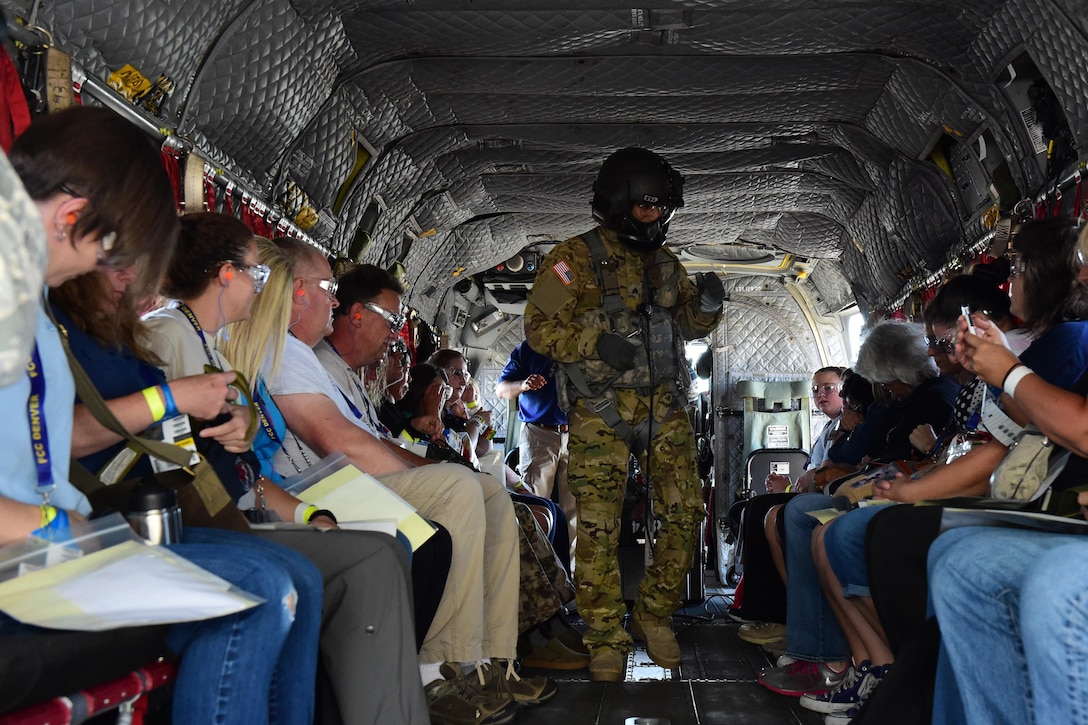 The air crew on a CH-47 Chinook helicopter instructs patients how to secure themselves in the aircraft during the annual National Disaster Medical System training exercise August 17, 2016, at Denver International Airport. The air crews transported over 100 patients from the DIA to Denver area hospitals. (U.S. Air Force photo by Airman 1st Class Gabrielle Spradling/Released)