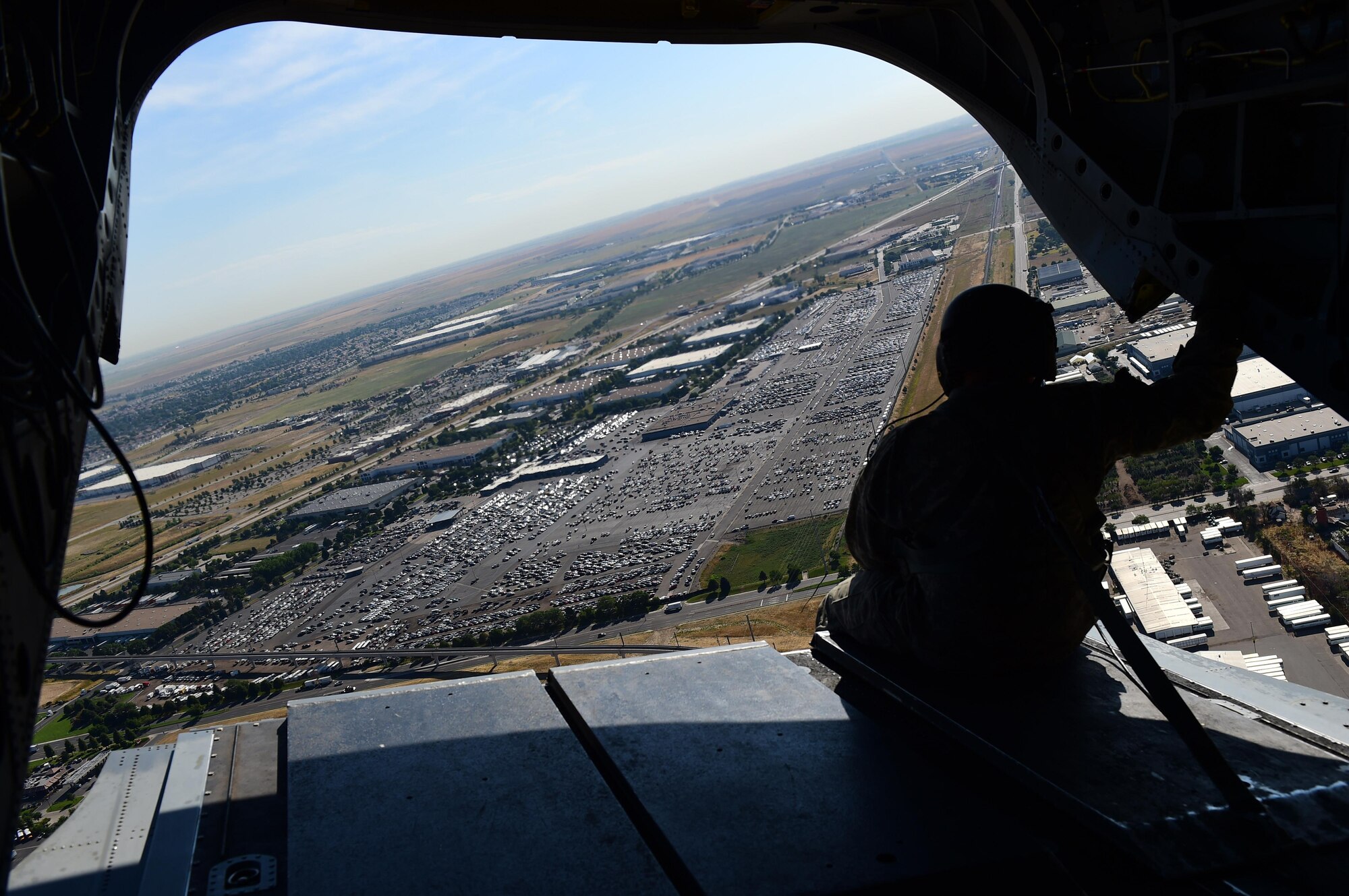 The air crew on a CH-47 Chinook helicopter sits on the platform of the aircraft during the annual National Disaster Medical System training exercise August 17, 2016, over Denver. NDMS included five Colorado Army National Guard helicopters that transported over 100 patients to various Denver area hospitals. (U.S. Air Force photo by Airman 1st Class Gabrielle Spradling/Released)