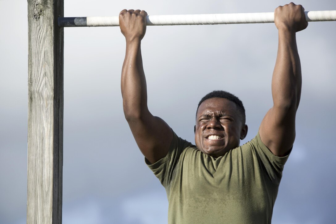 Marine Corps Lance Cpl. Evian T. Jackson participates in a pullup event during the 75th anniversary field competition at Marine Corps Air Station Cherry Point, N.C., Aug. 12, 2016. Marines from various ranks and ages compete in events to test their strength, teamwork and unit spirit. Jackson is an administrative specialist assigned to Headquarters Squadron. Marine Corps photo by Cpl. N.W. Huertas
