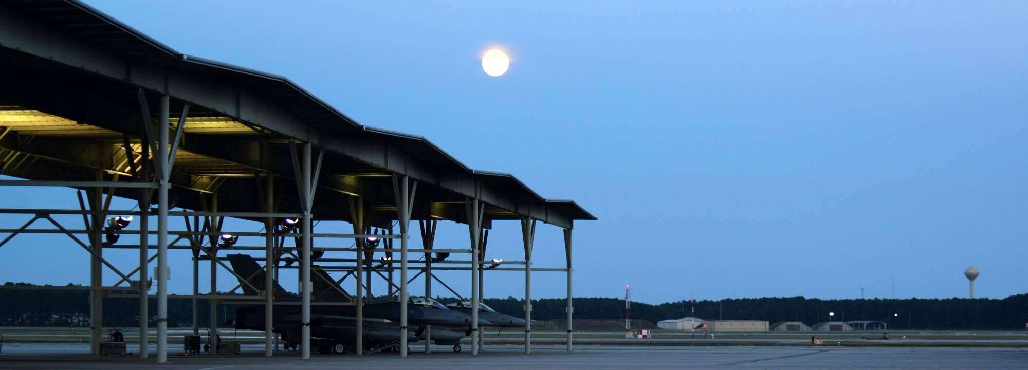 The moon shines over the flightline at Shaw Air Force Base, S.C., Aug. 17, 2016. Airmen assigned to the 20th Maintenance Group work all hours of the day to ensure Shaw’s 79 F-16CM Fighting Falcons are ready to deploy any time. (U.S. Air Force photo by Airman 1st Class Kelsey Tucker)
