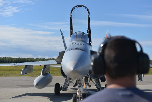 Royal Canadian Air Force Cpl. Zach McCann, an aviation systems technician assigned to the 409th Tactical Fighter Squadron out of Canadian Forces Base Cold Lake, Alberta, waits for Captain Chris Swartz, a pilot assigned to the same unit, to get ready for takeoff procedures during RED FLAG-Alaska (RF-A) 16-3, at Eielson air Force Base, Alaska, Aug. 18, 2016. RF-A participants fly to the Joint Pacific Alaska Range Complex, which provides more than 67,000 square miles of airspace for a realistic training environment. (U.S. Air Force photo by Airman Isaac Johnson)