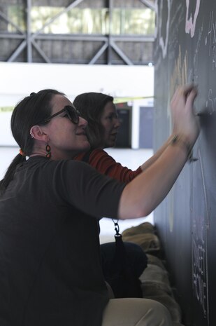 Allysyn Lasch, Family Advocacy intervention specialist and military spouse, writes on a chalkboard Aug. 17, 2016, at Beale Air Force Base, California. The chalkboard was part of a resiliency day event for participants to write and share their deployment experiences. (U.S. Air Force photo by Senior Airman Tara R. Abrahams)
