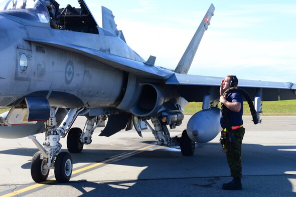 Royal Canadian Air Force Avr. Laurie Dunbar, an avionics systems technician assigned to the 409th Tactical Fighter Squadron, Canadian Forces Base Cold Lake, Alberta, renders a salute to Captain Yuri Mokievsky, a pilot assigned to the same unit, before he takes off from the Eielson Air Force Base, Alaska, flight line during RED FLAG-Alaska 16-3, Aug. 18, 2016. RF-A provides the most realistic simulated combat environment possible focusing on air combat at the tactical and operational levels. (U.S. Air Force photo by Airman 1st Class Cassandra Whitman)