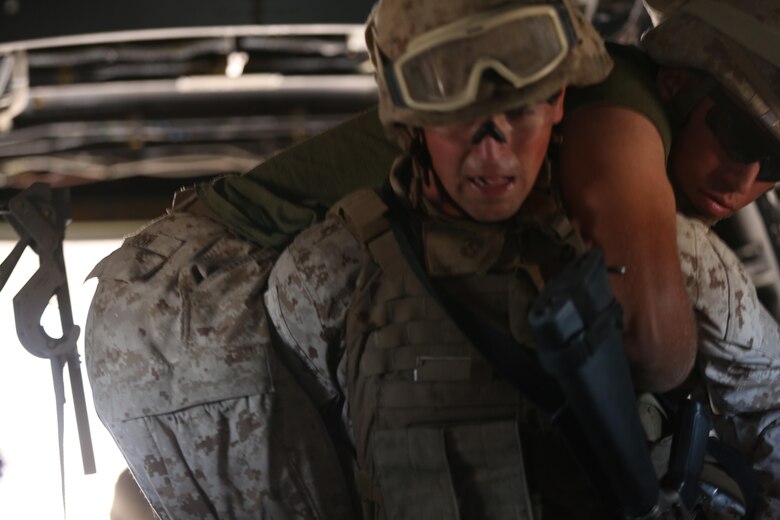 A Marine with 5th Battalion, 11th Marine Regiment, loads a simulated casualty onto an MV-22B Osprey during a casualty evacuation exercise aboard Marine Corps Base Camp Pendleton, Calif., Aug. 17. Marine Medium Tiltrotor Squadron (VMM) 161 supported 5th Battalion, 11th Marines, in order to increase proficiency in conducting CAS EVACS. (U.S. Marine Corps photo by Pfc. Jake M. T. McClung/Released)