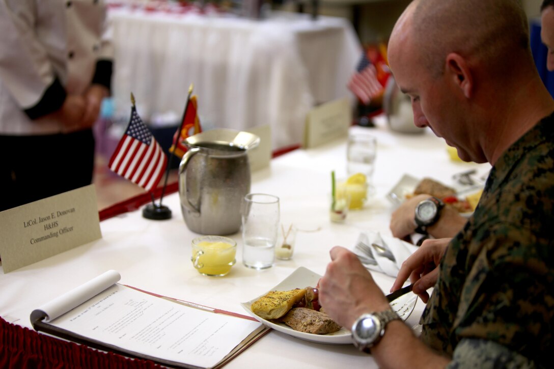 Lt. Col. Jason Donovan tastes Sgt. Megan McGuire’s main entree during the Headquarters and Headquarters Squadron’s Chef of the Quarter Competition aboard Marine Corps Air Station Cherry Point, N.C., Aug. 18, 2016. The quarterly competition tests food service specialists on the taste of their food, plate display, table appearance and culinary knowledge based on the anniversary theme they were given. Donovan, a judge during the competition, is the commanding officer for H&HS and McGuire is a food service specialist with H&HS. (U.S. Marine Corps photo by Cpl. Jason Jimenez/Released)