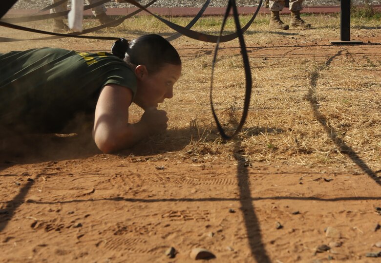 A Marine low crawls under netting during the 2nd Annual Tactical Athlete Championship aboard Marine Corps Air Station Miramar, Calif., Aug. 18. The competition was a part of the Marine Corps’ High Intensity Tactical Training program and tested the strengths and abilities of Marines from different installations around the Corps. (U.S. Marine Corps photo by Pfc. Liah Kitchen/Released)