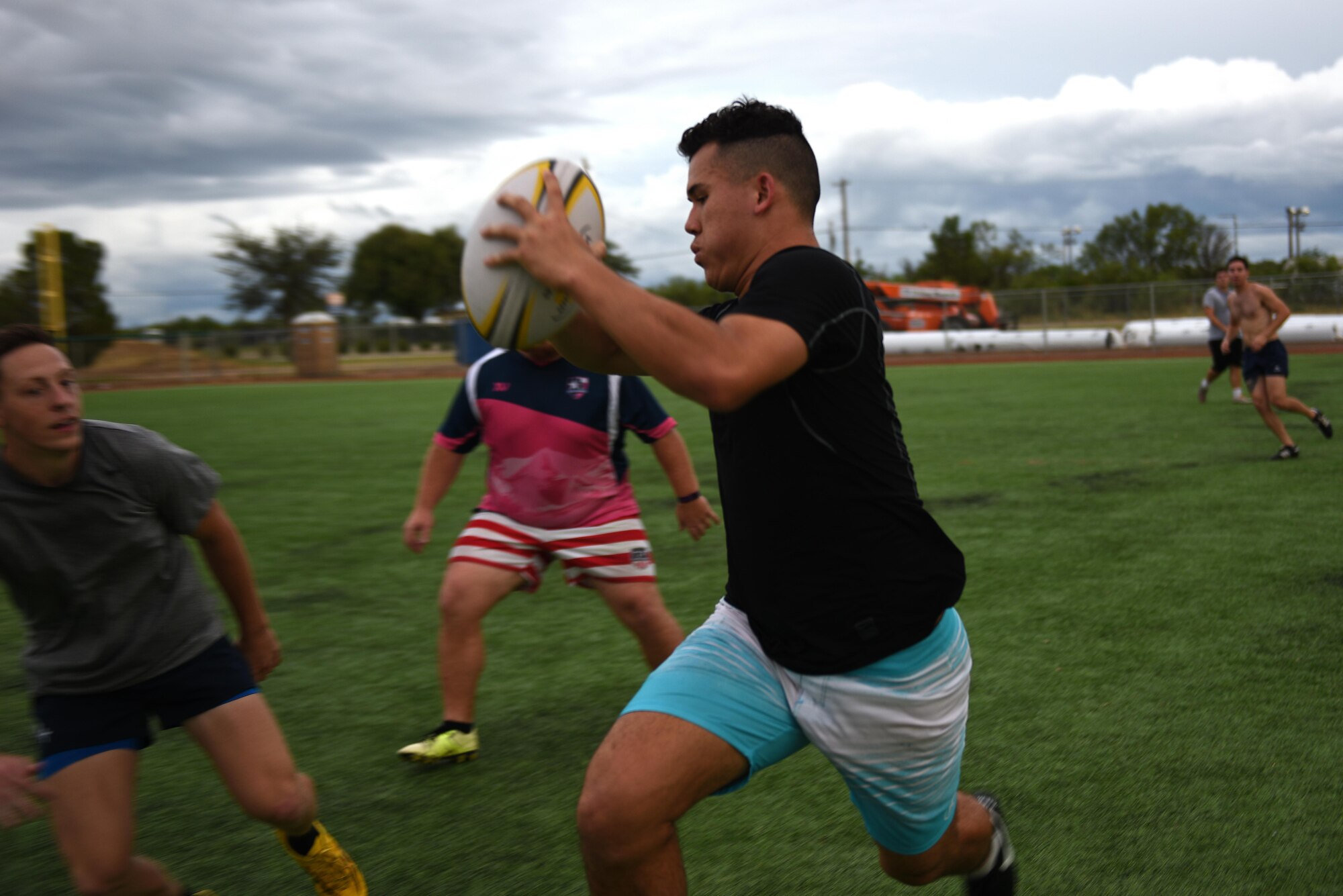 Rugby club members compete against each other during practice on the base softball field on Goodfellow Air Force Base, Texas, Aug. 17, 2016. In order to keep the players from being injured, the practice games are played by two-hand touches to simulate a tackle. (U.S. Air Force photo by Airman 1st Class Caelynn Ferguson/Released)