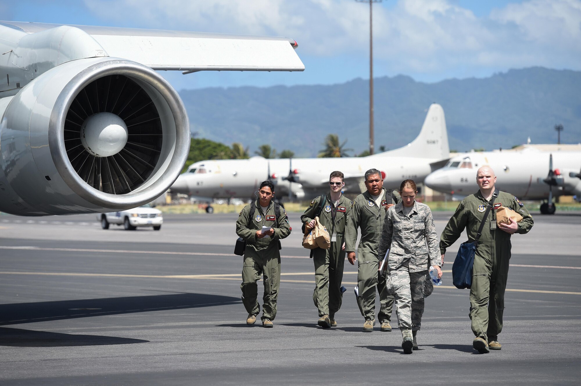 Reservists assigned to the 513th Air Control Group, walk by an E-3 Sentry wing July 25, 2016, at Joint Base Pearl Harbor-Hickam, Hawaii. More than 125 Airmen from the 513th Air Control Group and 552nd Air Control Wing are deployed to Hawaii in support of the Rim of the Pacific 2016 exercise. Twenty-six nations, more than 40 ships and submarines, more than 200 aircraft and 25,000 personnel are participating in RIMPAC from June 30 to Aug. 4, in and around the Hawaiian Islands and Southern California. The world's largest international maritime exercise, RIMPAC provides a unique training opportunity that helps participants foster and sustain the cooperative relationships that are critical to ensuring the safety of sea lanes and security on the world's oceans. RIMPAC 2016 is the 25th exercise in the series that began in 1971. (U.S. Air Force photo by 2nd Lt. Caleb Wanzer)