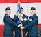 Col. David Gaedecke, 552nd Air Control Wing commander, left, passes the 552nd Maintenance Group guidon to Col. Brian Moore during a change of command ceremony held Aug. 8. Awaiting the guidon is Chief Master Sgt. Mike Phillippe, 552nd MXG superintendent. Colonel Moore succeeded Col. Andre Kennedy who retired from active duty. Colonel Moore previously served as the assistant deputy director for Joint Strategy and Plans at the Pentagon. (Air Force photo by Senior Master Sgt. Tom Edwards)