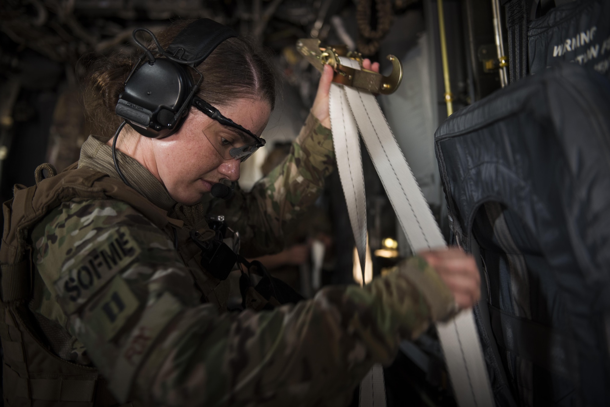 Capt. Casey Fox, a flight physician assistant with the 1st Special Operations Medical Group, straps down a litter during Task Force Exercise Olympus Archer at Wright Patterson Air Force Base, Ohio, Aug. 18, 2016.  Olympus Archer focuses on maximizing training opportunities for more than 230 Air Commandos, with the 1st Special Operations Wing, emphasizing on medical operations in conjunction with flying operations. (U.S. Air Force photo by Staff Sgt. Christopher Callaway)