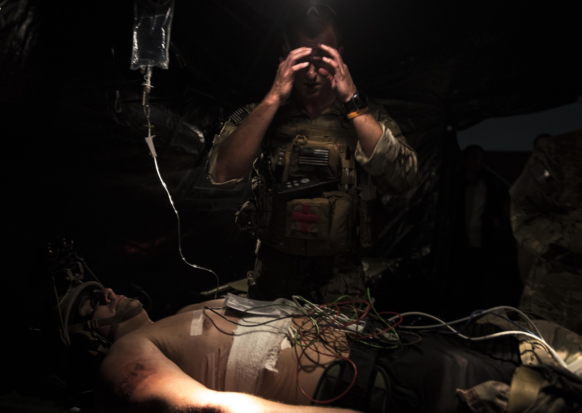 Capt. Aaron Thomas, a flight surgeon with the 1st Special Operations Medical Group, wipes sweat off his forehead during Task Force Exercise Olympus Archer at Wright Patterson Air Force Base, Ohio, Aug. 18, 2016. Olympus Archer focuses on maximizing training opportunities for more than 230 Air Commandos, with the 1st Special Operations Wing, emphasizing on medical operations in conjunction with flying operations. (U.S. Air Force photo by Staff Sgt. Christopher Callaway)