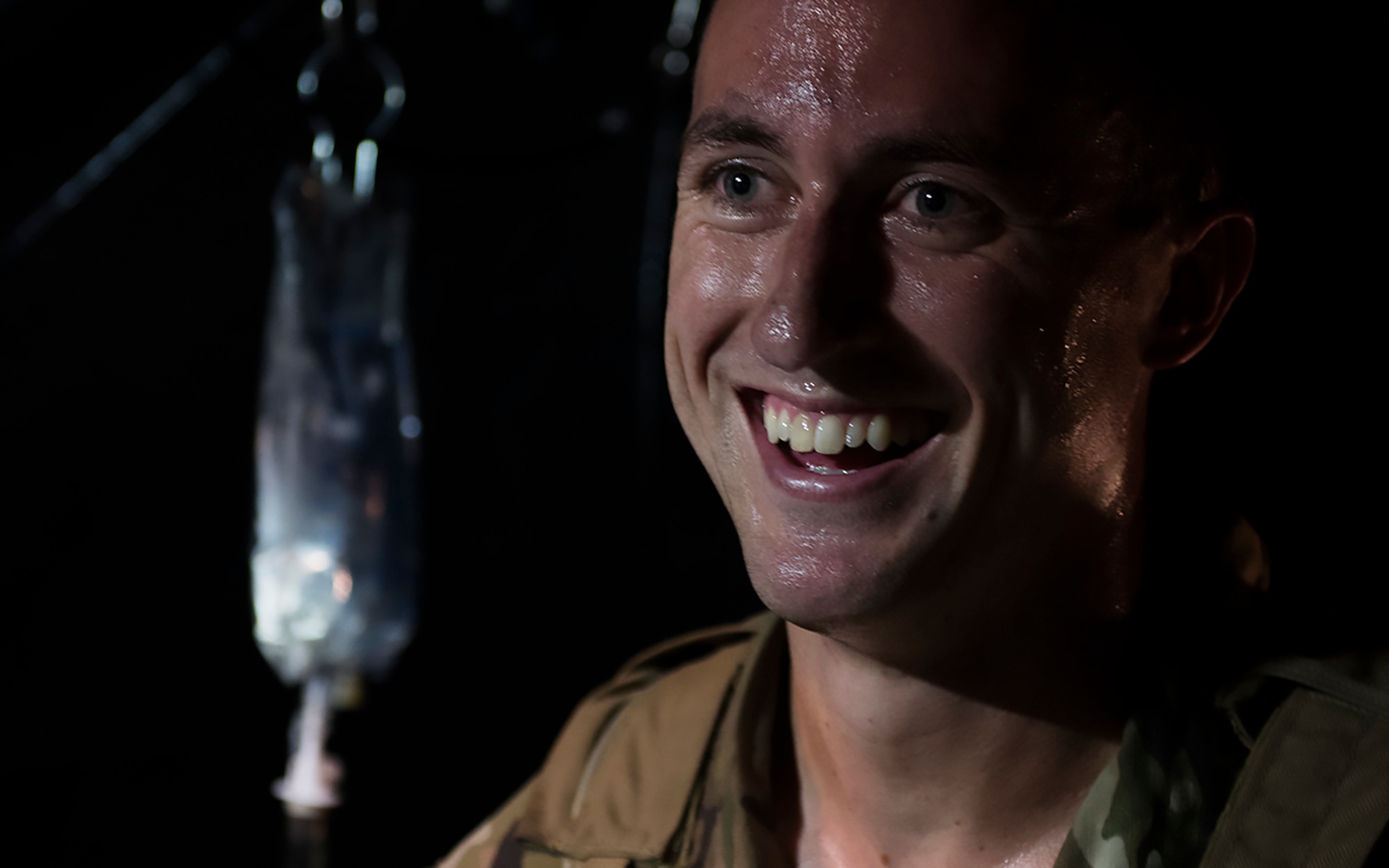 Capt. Aaron Thomas, a flight surgeon with the 1st Special Operations Medical Group, smiles after completing care on a patient during Task Force Exercise Olympus Archer at Wright Patterson Air Force Base, Ohio, Aug. 18, 2016. Olympus Archer focuses on maximizing training opportunities for more than 230 Air Commandos, with the 1st Special Operations Wing, emphasizing on medical operations in conjunction with flying operations. (U.S. Air Force photo by Staff Sgt. Christopher Callaway)